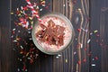 topdown view of a chocolate milkshake with sprinkles and cherry