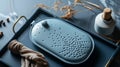 A topdown view of a hand warmer in the shape of a hot water bottle filled with heatretaining beads and featuring a