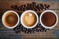Topdown View Of Three Coffee Cups On A Wooden Table, Showcasing Beans, Grounds, And Brewed Coffee