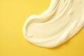 Topdown View Of White Cream Smear On Yellow Background