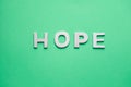 Tope view of wooden letters on the green backgrounds writing the word hope with capital letters Royalty Free Stock Photo