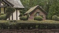 Topiary animals on the top of a yew hedge with buildings in the background Royalty Free Stock Photo