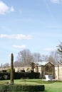 Topiary and lawn outside a stone wall