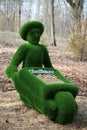 Topiary sculpture of a man with a cart