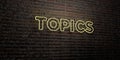 TOPICS -Realistic Neon Sign on Brick Wall background - 3D rendered royalty free stock image
