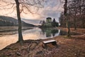 Topky pension with bench on foreground on shore of Pocuvadlo lake during winter