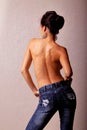 Topless asian woman in blue jeans