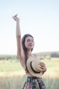 topless brunette woman covering her breasts with straw hat in the field Royalty Free Stock Photo