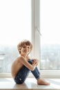 Topless kid portrait near the window Royalty Free Stock Photo