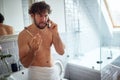 Topless man fighting while brushing teeth Royalty Free Stock Photo