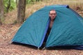 Topless man gets up in the morning in his camping tent Royalty Free Stock Photo