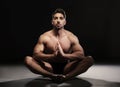 Topless Muscular Man Sitting in a Yoga Position