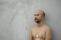 Topless bald beard portrait of adult man with grey cement wall background