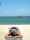 Topless suntanning at beach Royalty Free Stock Photo