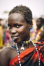 TOPOSA TRIBE, SOUTH SUDAN - MARCH 12, 2020: Young woman with piercing and short hair smiling and looking at camera while living in