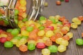 Toppled over glass jar full of colorful sweets