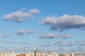 Tops of city roofs and construction crane over blue cloudy sky Royalty Free Stock Photo