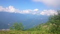 The tops of the high mountain slope of the black pyramid, with a cable car in front of which is the valley. Blue sky in the Royalty Free Stock Photo