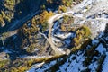 The tops of the mountains covered with snow. The slopes are thickets of yellow and green trees. Royalty Free Stock Photo