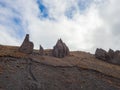 On the tops of the mountains under the cloudy sky are huge sharp stone battlements. Magmatic pyramids. The consequences