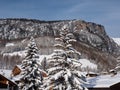 The Tops of Two Fir Trees filled with Snow after a Heavy Snowfall and the Snowy Italian Mountains on the background Royalty Free Stock Photo