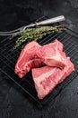 Topside sirloin beef cut, raw meat with spices. Black background. Top view