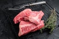 Topside sirloin beef cut, raw meat with spices. Black background. Top view