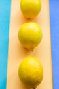 Topv view of three lemons on colorful pastel background Royalty Free Stock Photo