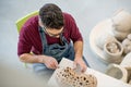 Topview of Ceramist Dressed in an Apron Sculpting Statue from Raw Clay in Bright Ceramic Workshop. Royalty Free Stock Photo