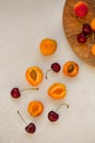 Topview image of apricots and cherries on light gray tabletop Royalty Free Stock Photo