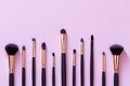 Topview makeup brushes set on a pink backdrop