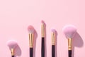 Topview makeup brushes set on a pink backdrop