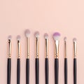 Topview makeup brushes set on a pink backdrop