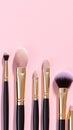 Topview makeup brushes set on a pink backdrop