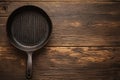 Topview of an old grill pan, empty, on rustic oak