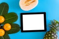 Topview of orange,pineapple, cantaloupe with desktop with blank