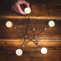 Topview of a wooden pentagram with candles, occultism and mysticism