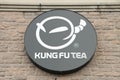 tor, canada - august 12, 2023: kung fu tea circle cylinder logo on side of store storefront in summer, black. p94 13