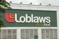 tor, canada - July 1, 2023: close up of loblaws great food logo on store with tree branches in foreground-.