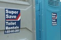 tor, canada - July 16, 2023: two porta portable potties next to each other, one gray and one blue, super save. p Royalty Free Stock Photo