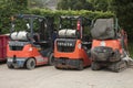 tor, canada - July 2, 2023: two toyota propane forklifts orange and black parked next to another orange-.