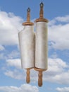 Torah scrolls on parchment paper with blue sky background