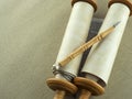 Torah scrolls on a wooden table close-up on a background of gray linen canvas. Royalty Free Stock Photo
