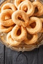 Torcetti Traditional Italian Butter Cookies closeup on the plate on the table. Vertical top view