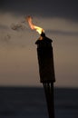 Torch on the beach at sunset. Royalty Free Stock Photo