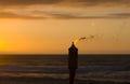 Torch on the beach at sunset. Royalty Free Stock Photo