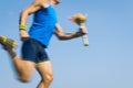 Torchbearer Athlete Running with Sport Torch Blue Sky Royalty Free Stock Photo