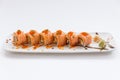 Torched Salmon Maki Sushi with Shrimp Tempura, Avocado and Cheese inside. Topping with Sauce, Ebiko Shrimp Egg and Scallion Royalty Free Stock Photo