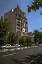 Tall building with a blue dome, spire, gazebos, columns and oval windows on Moalem street in the capital of the Islamic Republic