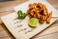 Tori kawa no karaage - japanese style deep fried chicken skin with salt and lime on wooden background , stock photo Royalty Free Stock Photo